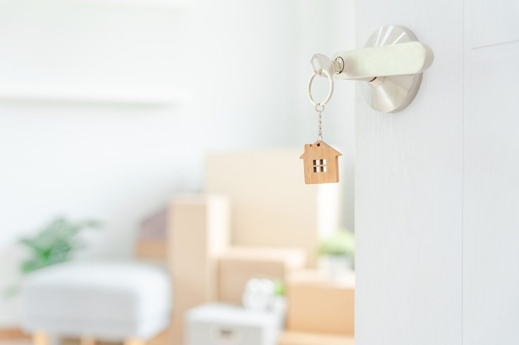 Keyring in door with moving boxes in background. 