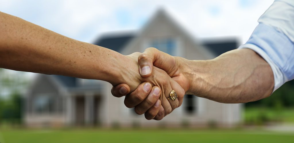 Shaking hands outside a house - afinestpm.com.