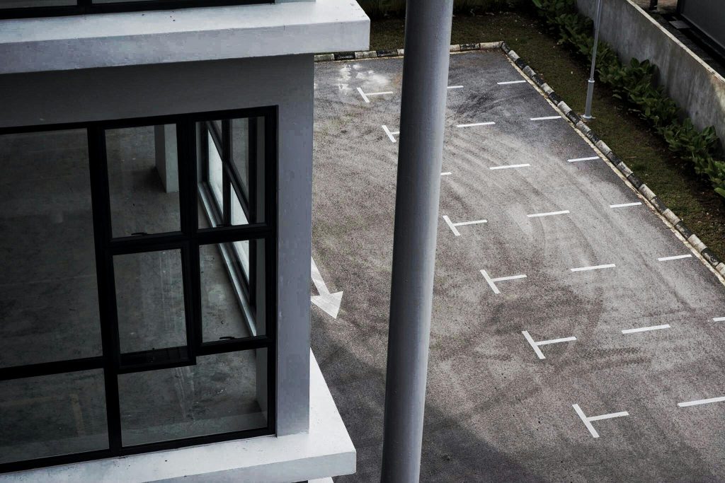 Empty commercial building and adjoining parking lot - Visit afinestpm.com. 