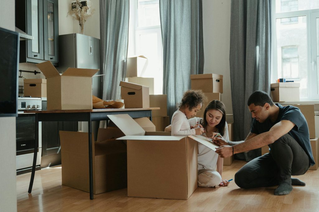 Be Move-In Ready with America's Finest Property Management 28 Two parents and a child unpacking boxes in their new home.