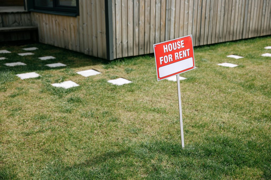 House for Rent sign on green lawn - visit AfinestPM.com.