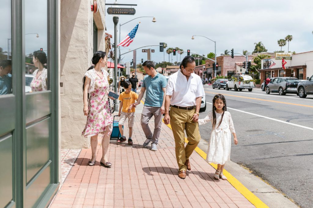 Family walking on sidewalk in San Diego - Visit AFinestPM.com. 